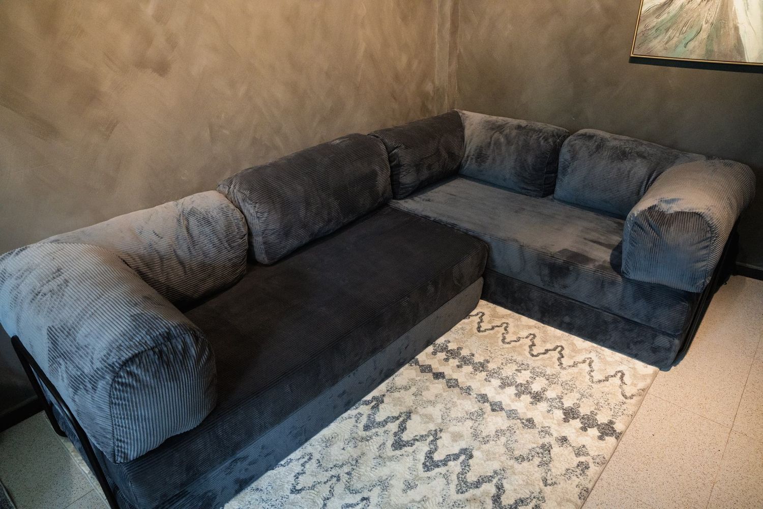 The slate grey Cloud Corner filling a warm, softly lit room.